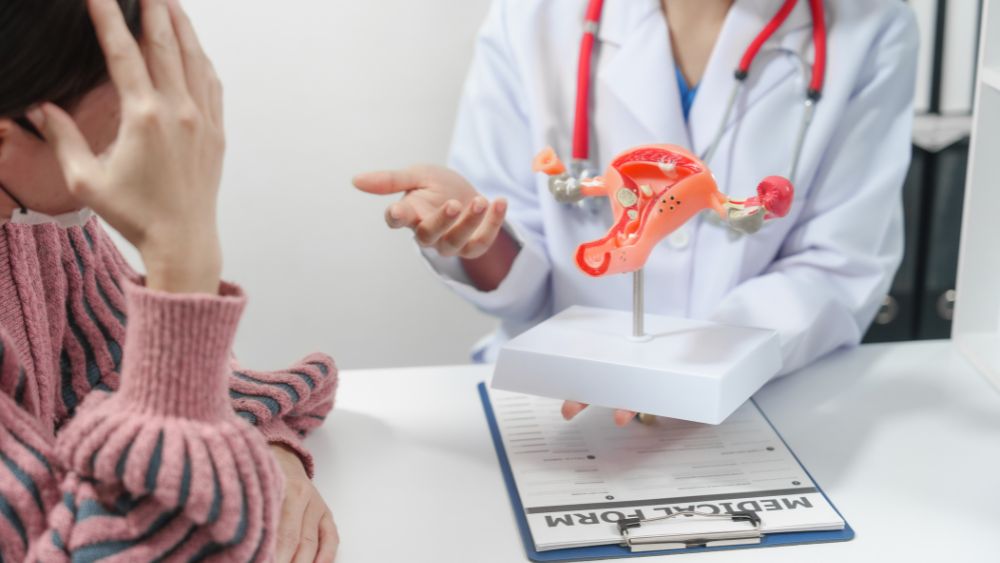 Female doctor explaining a uterus model to a patient